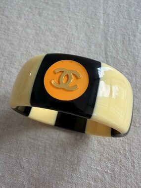 ✨CHANEL Black and Cream Resin CC Logo Cuff with Orange Accent💛